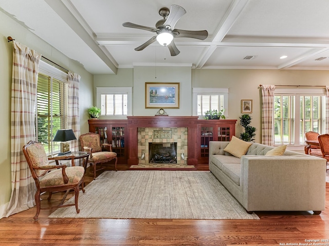 207 Queen Anne, San Antonio, TX 78209 - living room featuring healthy amount of natural light, beamed ceiling, coffered ceiling, a stone fireplace, and wood finished floors