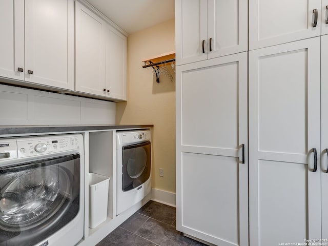 207 Queen Anne, San Antonio, TX 78209 - washroom featuring washer and dryer, cabinet space, baseboards, and dark tile patterned floors