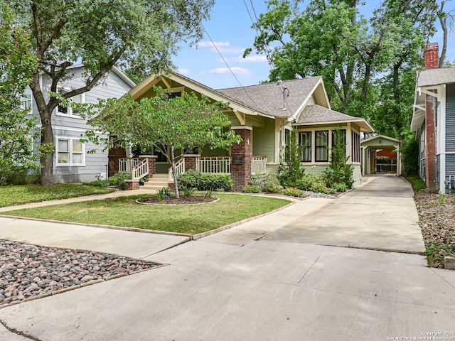 207 Queen Anne, San Antonio, TX 78209 - view of front of home with driveway, a front yard, brick siding, a shingled roof, and a detached carport