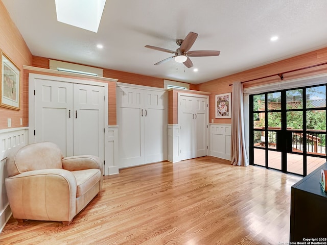 207 Queen Anne, San Antonio, TX 78209 - sitting room featuring a wall unit AC, ceiling fan, light wood-style floors, a decorative wall, and recessed lighting