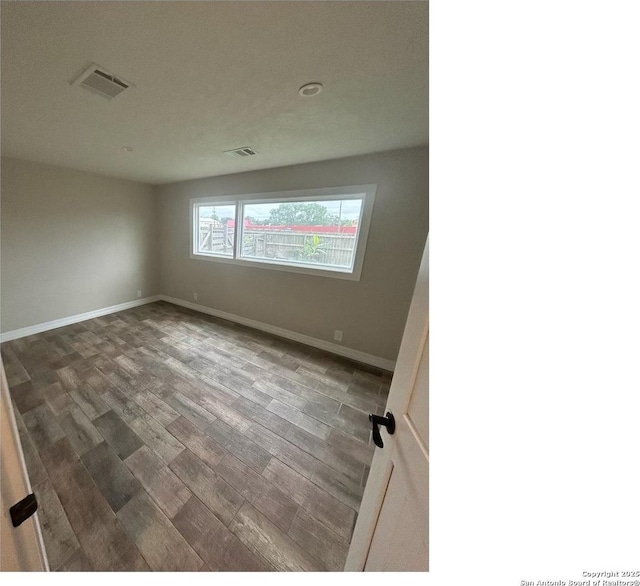 1924 Owens Ave, Groves, TX 77619 - unfurnished room featuring wood finished floors and baseboards