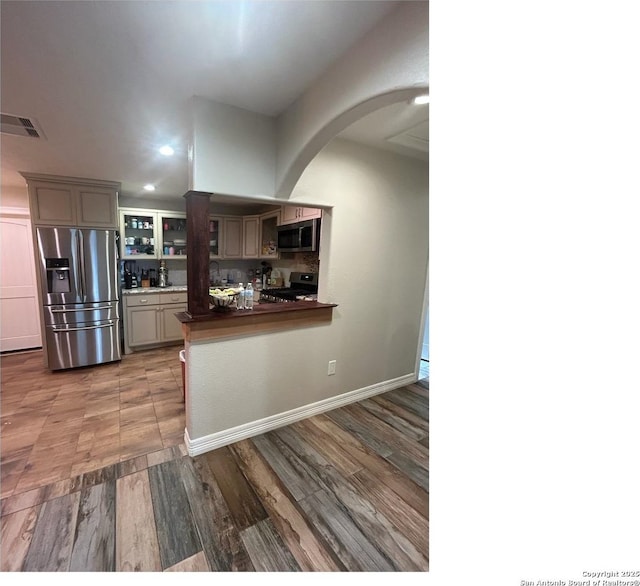 1924 Owens Ave, Groves, TX 77619 - kitchen with appliances with stainless steel finishes, dark countertops, arched walkways, recessed lighting, and gray cabinets