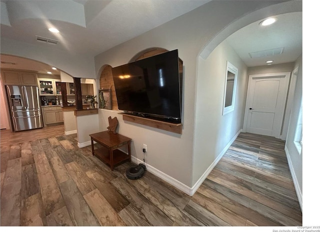 1924 Owens Ave, Groves, TX 77619 - hall featuring wood finished floors, arched walkways, recessed lighting, and baseboards
