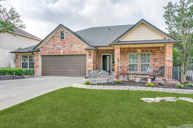 1002 Alpine Pond, San Antonio, TX 78260 - view of front of property featuring an attached garage, brick siding, a front lawn, concrete driveway, and covered porch