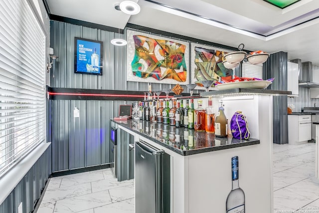 1002 Alpine Pond, San Antonio, TX 78260 - indoor dry bar with light marble finish floors, fridge, and wall chimney range hood