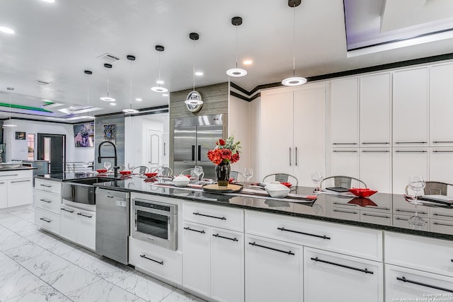 1002 Alpine Pond, San Antonio, TX 78260 - kitchen with stainless steel appliances, light marble finish floors, a sink, white cabinets, and recessed lighting