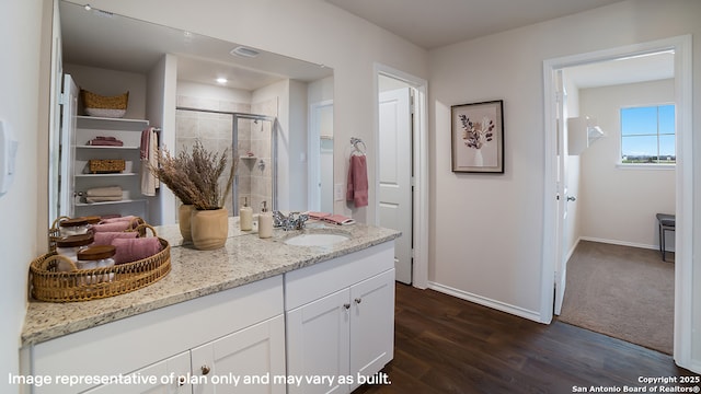 9807 Beaumont Brk, San Antonio, TX 78221 - bathroom with a shower stall, wood finished floors, baseboards, and vanity