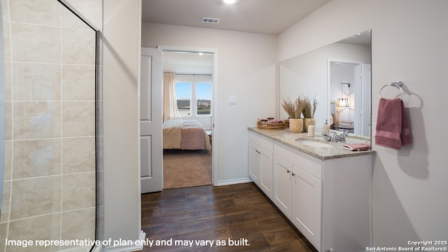 711 Garnier Pass, San Antonio, TX 78221 - full bathroom with ensuite bath, wood finished floors, vanity, and tiled shower