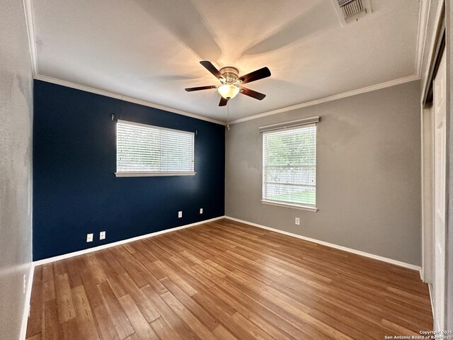4835 Castle Sword, San Antonio, TX 78218 - spare room featuring ornamental molding, a ceiling fan, wood finished floors, and baseboards
