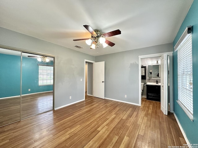 4835 Castle Sword, San Antonio, TX 78218 - unfurnished bedroom with wood finished floors, baseboards, a closet, and ceiling fan