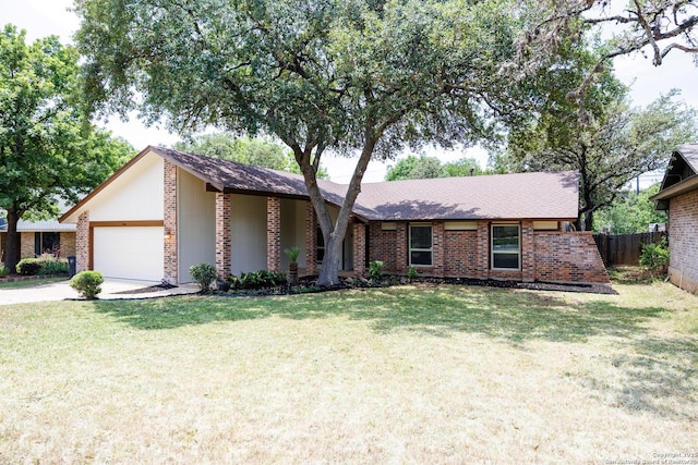 14613 Hook Dr, San Antonio, TX 78231 - mid-century home featuring an attached garage, brick siding, and concrete driveway