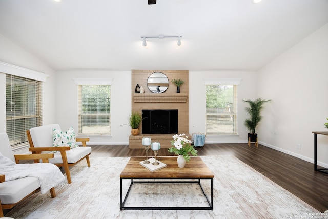 14613 Hook Dr, San Antonio, TX 78231 - living area featuring vaulted ceiling, healthy amount of natural light, a brick fireplace, and wood finished floors