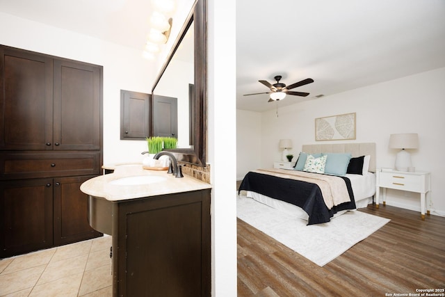 14613 Hook Dr, San Antonio, TX 78231 - bedroom featuring a sink, light wood-type flooring, and ceiling fan