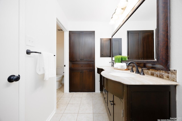 14613 Hook Dr, San Antonio, TX 78231 - bathroom with double vanity, tile patterned flooring, and toilet
