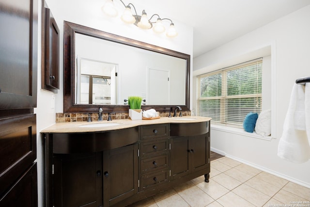 14613 Hook Dr, San Antonio, TX 78231 - full bathroom featuring tile patterned floors, double vanity, tasteful backsplash, and baseboards