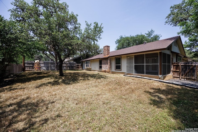 14613 Hook Dr, San Antonio, TX 78231 - rear view of house with a sunroom and a chimney