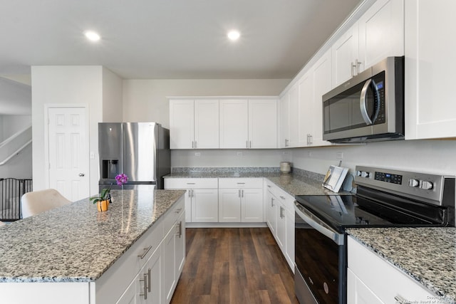 809 Altapass Hls, Seguin, TX 78155 - kitchen featuring stainless steel appliances, white cabinetry, light stone countertops, a center island, and recessed lighting
