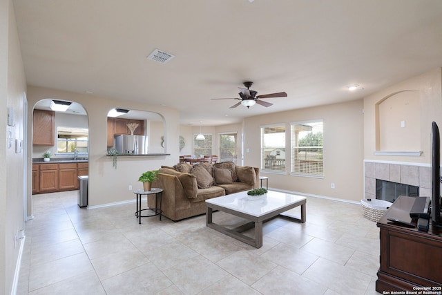 11106 Shetland Hls, San Antonio, TX 78254 - living area with a ceiling fan, light tile patterned floors, baseboards, and a fireplace