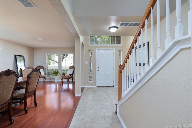 11106 Shetland Hls, San Antonio, TX 78254 - entrance foyer with arched walkways, baseboards, stairs, and wood finished floors