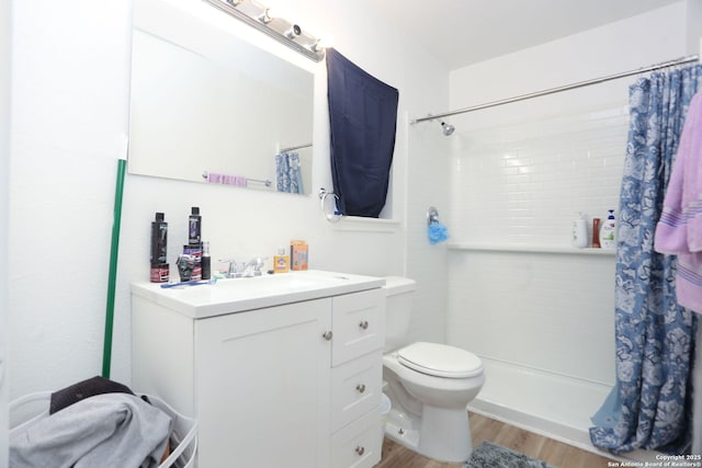 311 W Malone Ave, San Antonio, TX 78214 - full bath with wood finished floors, tiled shower, toilet, and vanity