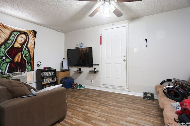 311 W Malone Ave, San Antonio, TX 78214 - living room with a ceiling fan, a textured ceiling, wood finished floors, baseboards, and cooling unit