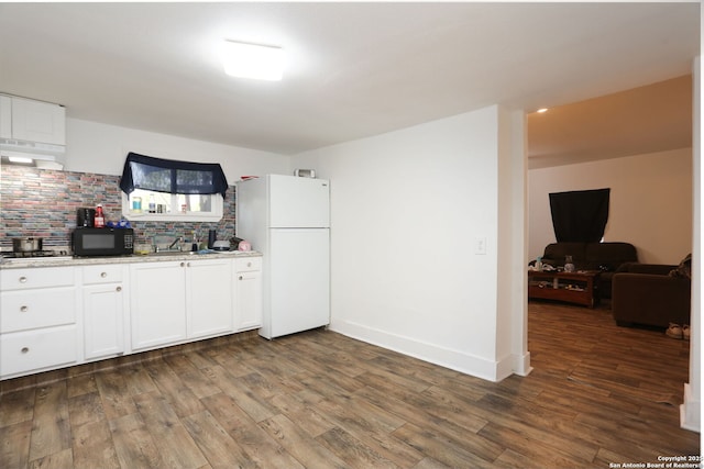 311 W Malone Ave, San Antonio, TX 78214 - kitchen featuring black microwave, freestanding refrigerator, backsplash, dark wood-style floors, and white cabinetry