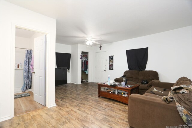 311 W Malone Ave, San Antonio, TX 78214 - living room with light wood finished floors, a ceiling fan, and baseboards