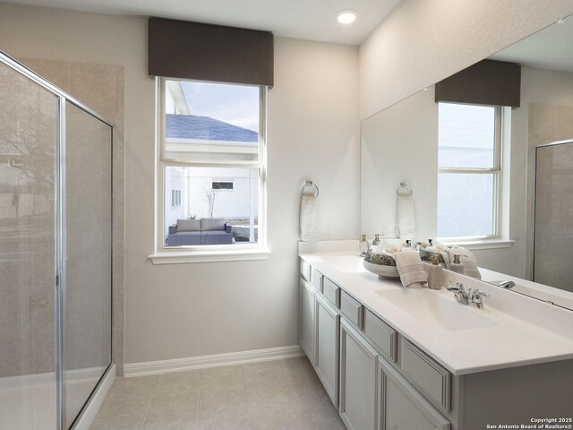 10238 King Robert, San Antonio, TX 78239 - bathroom featuring a shower stall, double vanity, baseboards, tile patterned floors, and recessed lighting