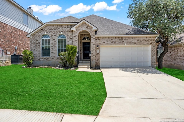 26430 Walden Oak, San Antonio, TX 78260 - french provincial home featuring a front yard, brick siding, a shingled roof, driveway, and cooling unit