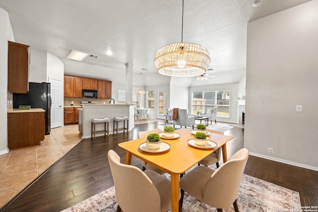 26430 Walden Oak, San Antonio, TX 78260 - dining space featuring ornate columns, baseboards, light wood finished floors, and a textured ceiling