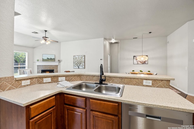 26430 Walden Oak, San Antonio, TX 78260 - kitchen featuring dishwasher, a sink, open floor plan, ceiling fan, and a tile fireplace