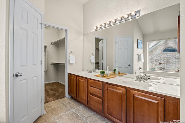 26430 Walden Oak, San Antonio, TX 78260 - bathroom with tile patterned flooring, double vanity, vaulted ceiling, and a closet