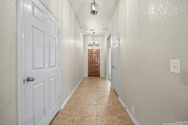 26430 Walden Oak, San Antonio, TX 78260 - doorway featuring a textured wall, a textured ceiling, light tile patterned floors, and baseboards