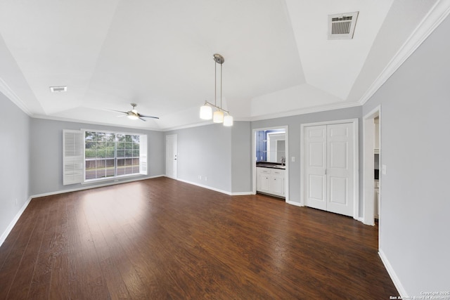 2611 Eisenhauer Unit 104A, San Antonio, TX 78209 - unfurnished living room with a tray ceiling, a ceiling fan, dark wood-style floors, and crown molding