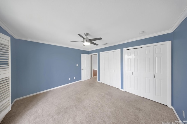 2611 Eisenhauer Unit 104A, San Antonio, TX 78209 - unfurnished bedroom with carpet flooring, multiple closets, baseboards, crown molding, and a ceiling fan