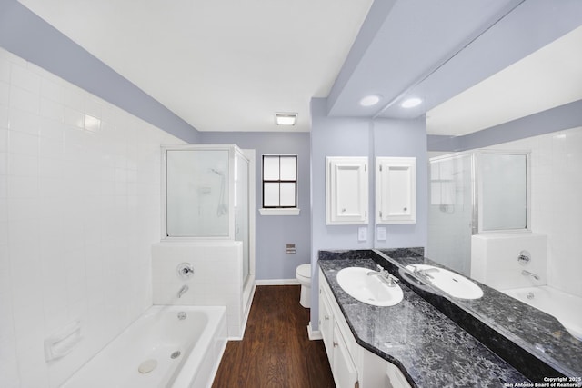 2611 Eisenhauer Unit 104A, San Antonio, TX 78209 - full bathroom with a stall shower, baseboards, a tub, vanity, and wood finished floors