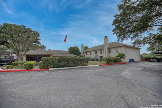 2611 Eisenhauer Unit 104A, San Antonio, TX 78209 - view of building exterior featuring uncovered parking