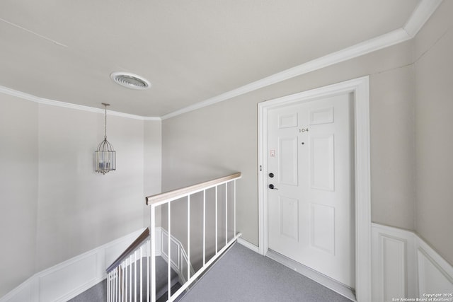 2611 Eisenhauer Unit 104A, San Antonio, TX 78209 - hall featuring an upstairs landing, ornamental molding, and wainscoting