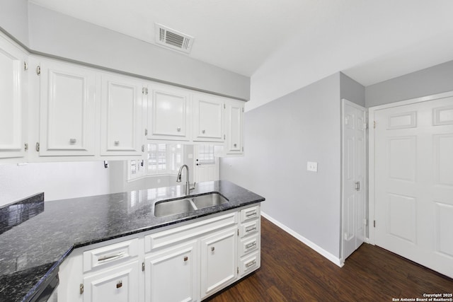 2611 Eisenhauer Unit 104A, San Antonio, TX 78209 - kitchen with dark wood-style flooring, dark stone countertops, and white cabinets