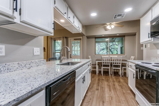 15310 Artesian Oaks, San Antonio, TX 78232 - kitchen featuring black appliances, a sink, white cabinets, light wood-type flooring, and a ceiling fan