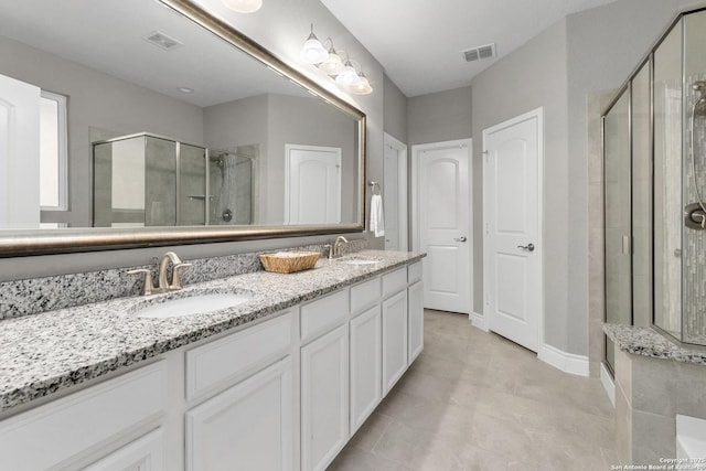 7635 Paraiso Crst, Boerne, TX 78015 - bathroom featuring a shower stall, double vanity, and baseboards