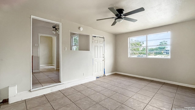 103 Pollydale Ave, San Antonio, TX 78223 - tiled spare room with a ceiling fan, healthy amount of natural light, and baseboards