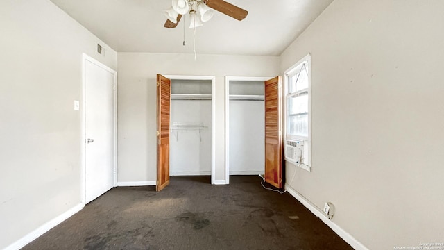 103 Pollydale Ave, San Antonio, TX 78223 - unfurnished bedroom featuring dark colored carpet, two closets, baseboards, ceiling fan, and cooling unit
