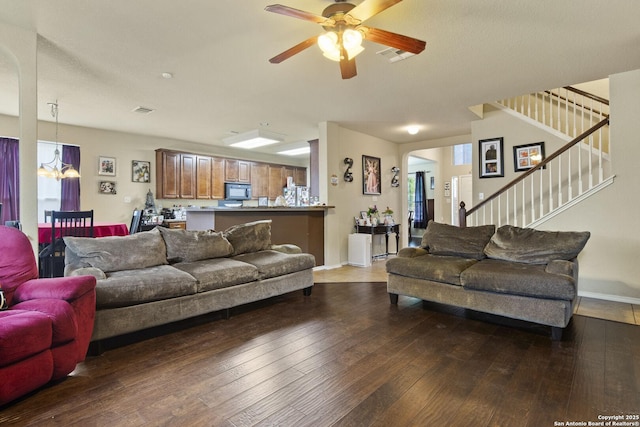 738 Daisy Xing, San Antonio, TX 78245 - living room featuring a chandelier, a ceiling fan, hardwood / wood-style flooring, stairs, and baseboards