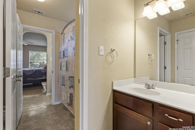 738 Daisy Xing, San Antonio, TX 78245 - bathroom featuring a textured wall, vanity, and baseboards