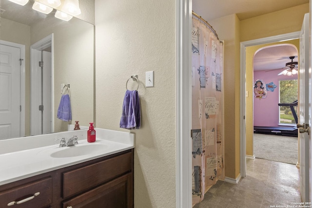 738 Daisy Xing, San Antonio, TX 78245 - bathroom with vanity, a textured wall, and a ceiling fan