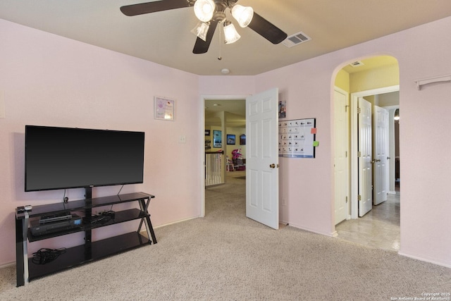 738 Daisy Xing, San Antonio, TX 78245 - living room featuring carpet floors, arched walkways, ceiling fan, and baseboards