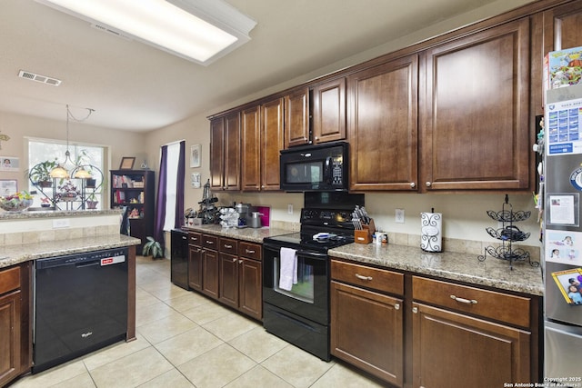 738 Daisy Xing, San Antonio, TX 78245 - kitchen featuring black appliances, light tile patterned floors, dark brown cabinetry, and decorative light fixtures