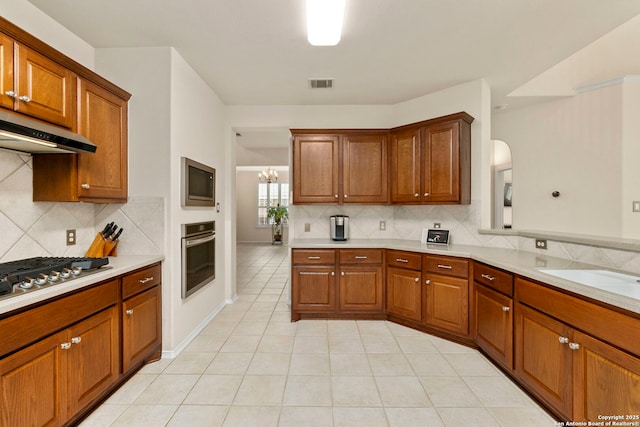 26223 Cuyahoga Cir, San Antonio, TX 78260 - kitchen with appliances with stainless steel finishes, under cabinet range hood, light countertops, and backsplash