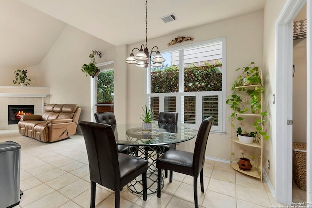 26223 Cuyahoga Cir, San Antonio, TX 78260 - dining space with light tile patterned flooring, a fireplace, a chandelier, vaulted ceiling, and baseboards